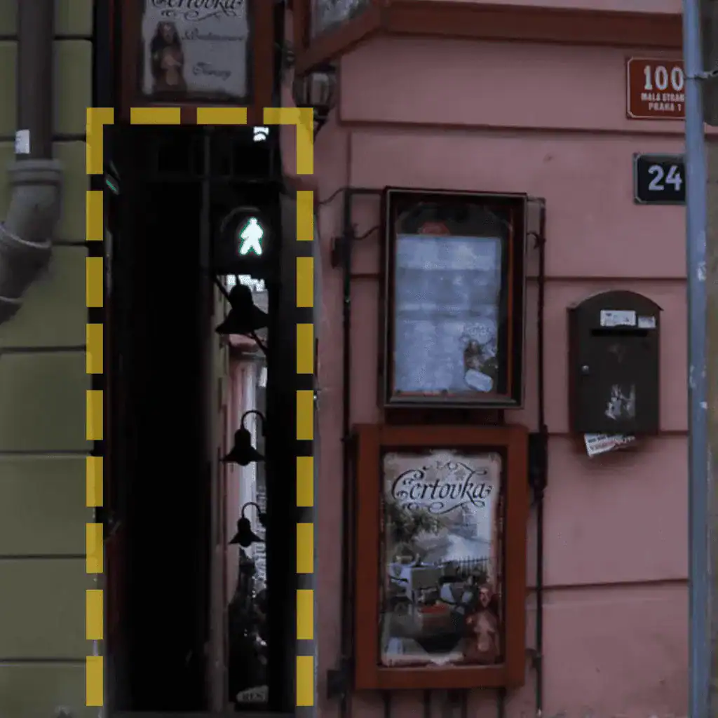 The narrowest alley in Prague, featuring a pedestrian traffic light at its entrance.